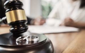 Wedding rings beside a judge's gavel